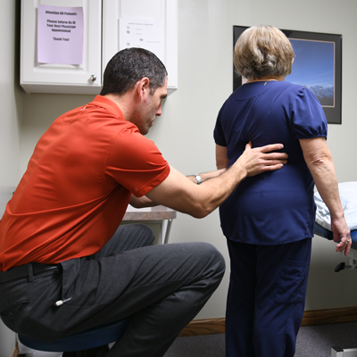 Therapist helping patient with balance therapy